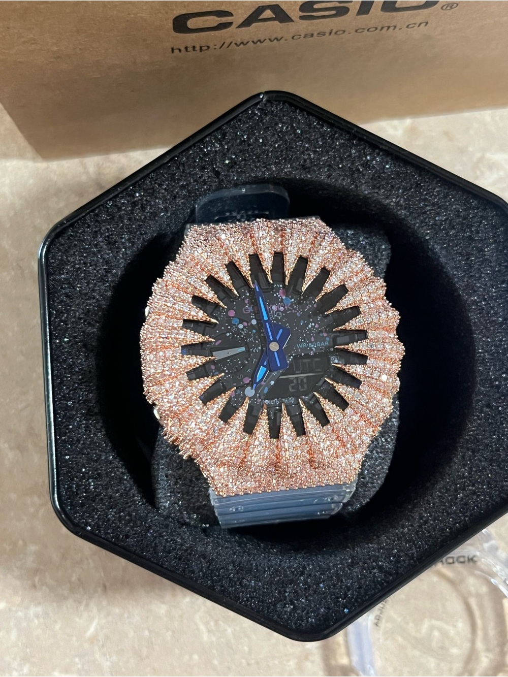 Casio watch with rose gold crystal bezel and blue hands